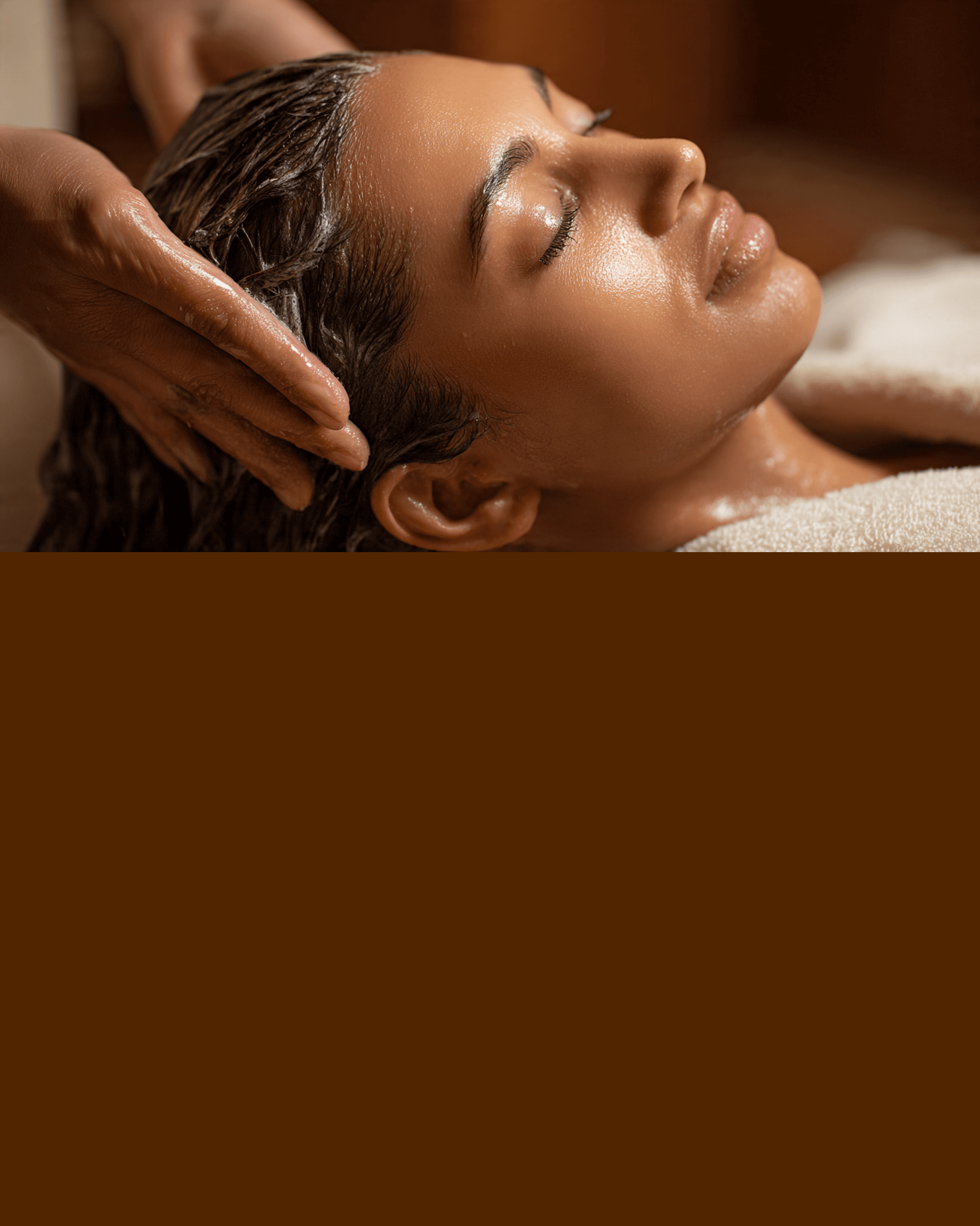 Hands massaging a woman's wet hair during a relaxing scalp treatment in a spa setting.