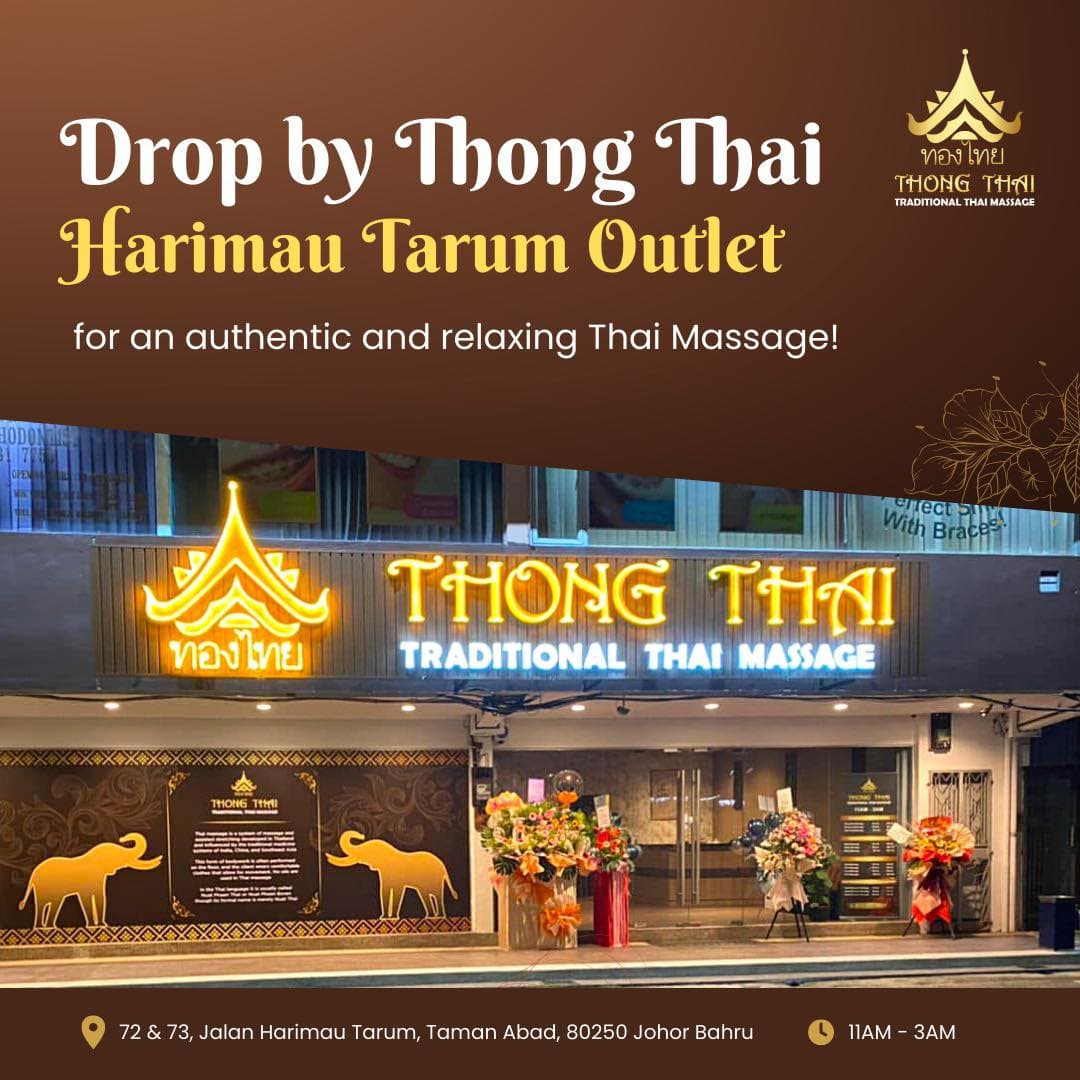 Storefront of Thong Thai Traditional Thai Massage Harimau Tarum outlet featuring glowing signage and address.